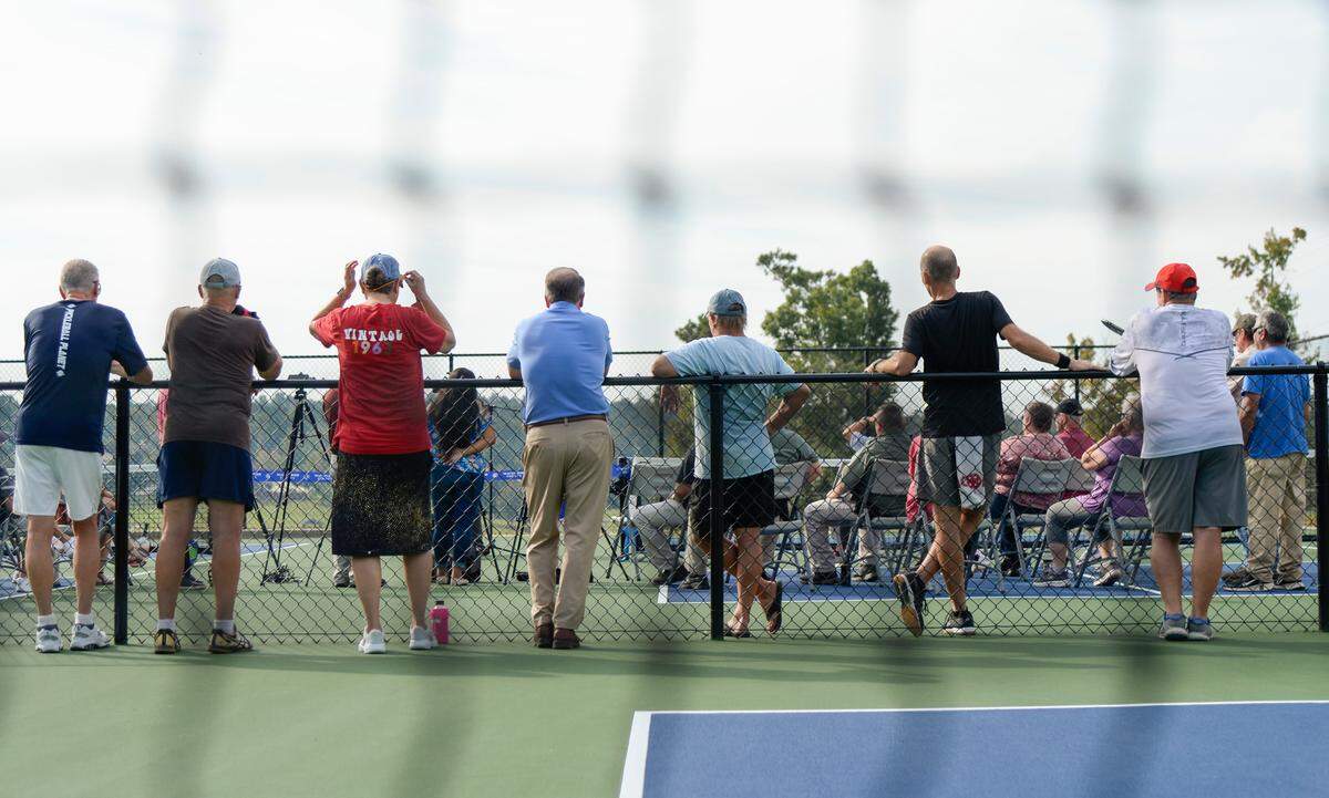 Pickleball players look on during a ribbon cutting ceremony for four new pickleball courts Thursday morning at Lake Tobesofkee.