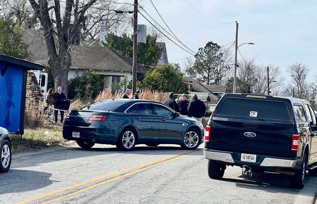 Bibb County and GBI investigators gather at the scene of an officer-inolved shooting Monday in south Macon.