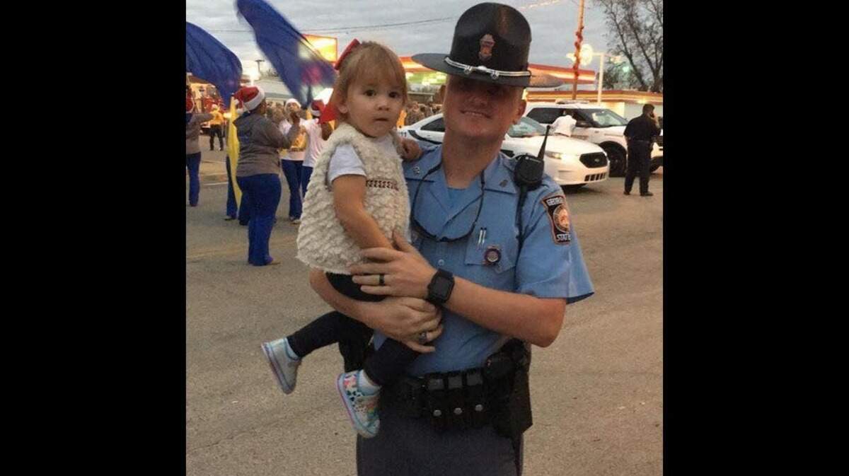 Georgia State Patrol Trooper Tyler Parker was killed Monday in a single-vehicle crash during heavy rain in Crisp County. His daughter,  Savannah, sustained serious injuries.