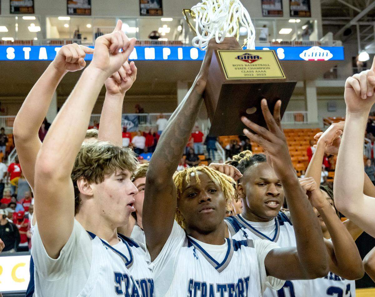 Stratford players celebrate the Eagles’ 65-64 GIAA State Championship win over St. Anne-Pacelli Saturday night at Mercer.