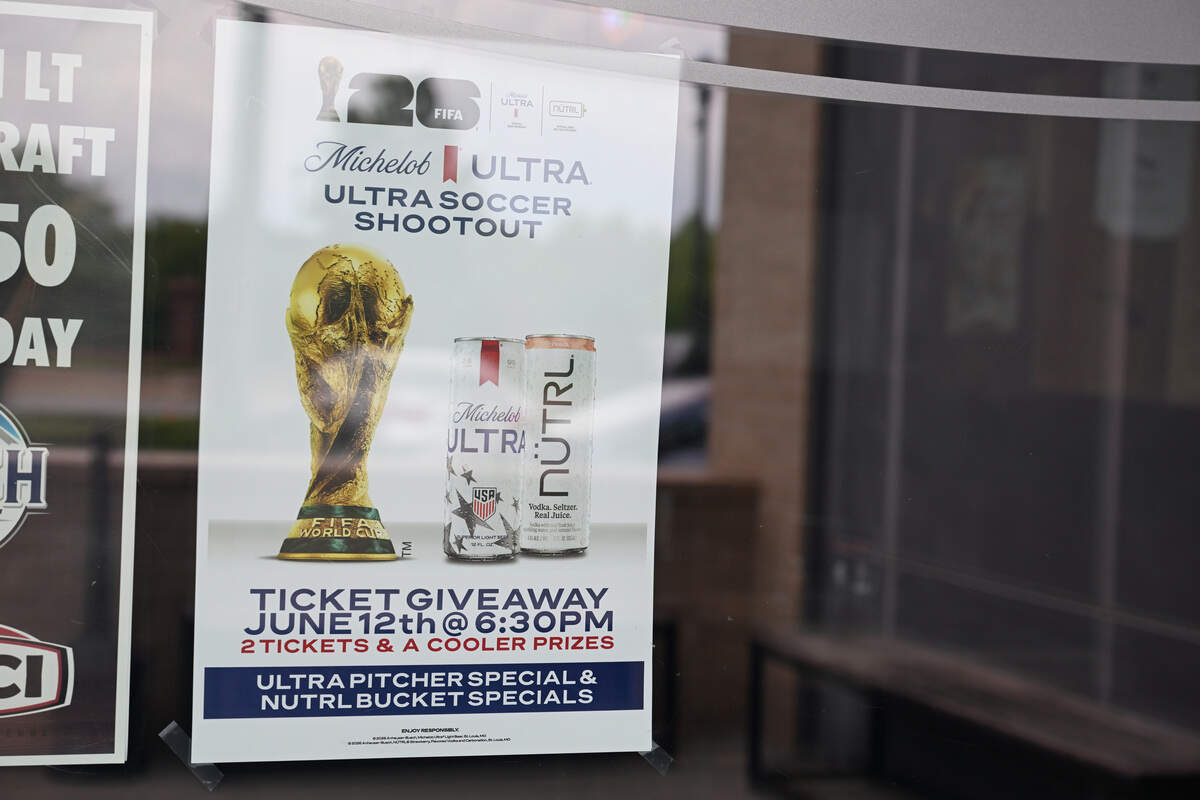 A poster hangs in the window of Amici Macon advertising the FIFA World Cup giveaway. Amici Macon is partnering with Anheuser-Busch to give away two pairs of World Cup match tickets in Atlanta.