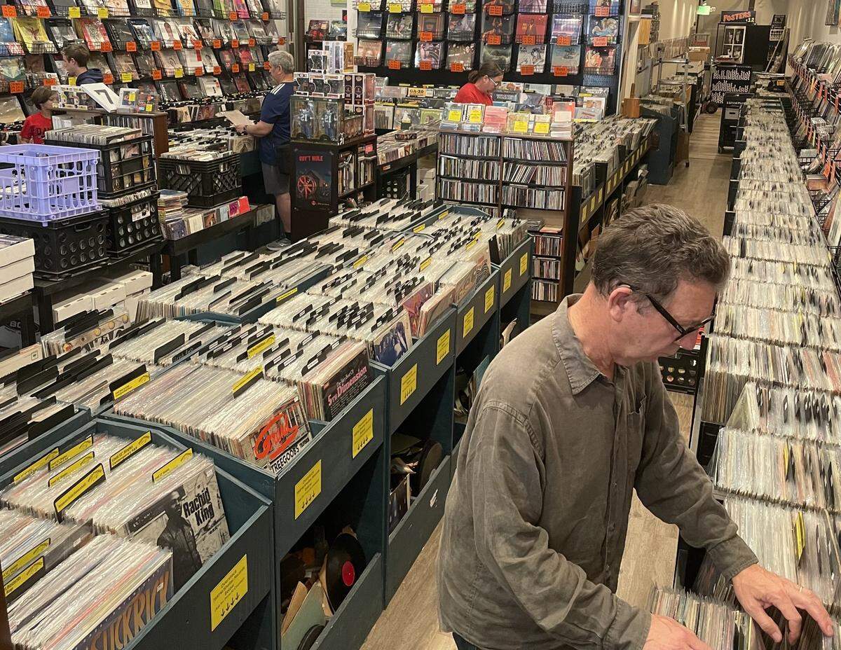 Customers browse the merchandise at Fresh Produce Records located in downtown Macon.