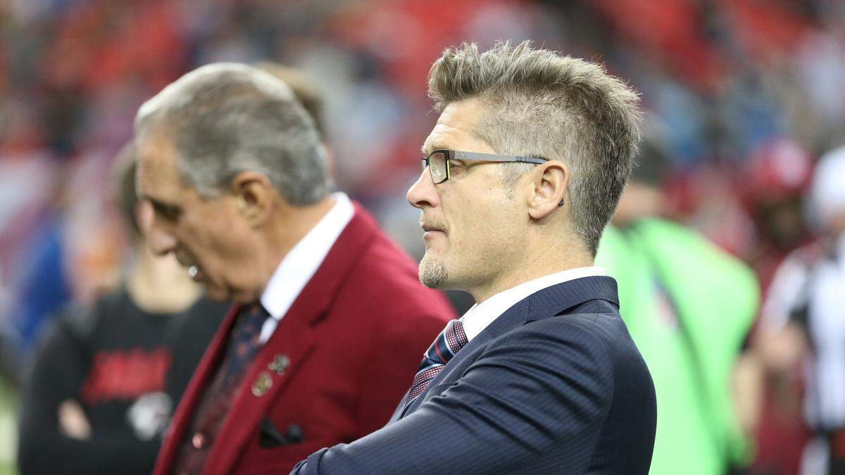 FILE - In this Dec. 27, 2015, file photo, Atlanta Falcons General Manager Thomas Dimitroff, right, stands next to Falcons owner Arthur Blank before the first half of an NFL football game against the Carolina Panthers in Atlanta. Blank says he is sticking with general manager Thomas Dimitroff, who he says has formed a productive management team with first-year coach Dan Quinn. Blank said Friday there will be changes in the pro personnel and scouting departments. (AP Photo/John Bazemore, File)