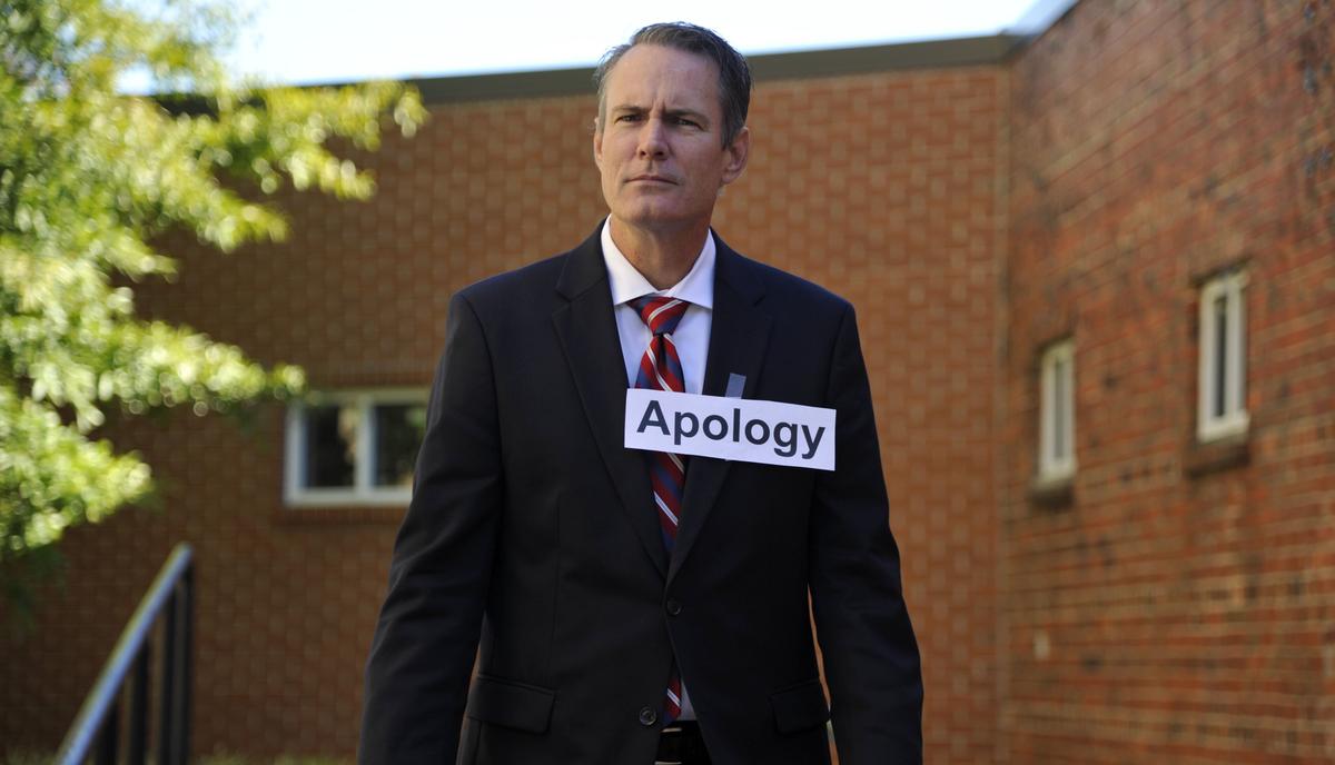 Joe Kovac, a reporter with The Macon Telegraph, models a halloween costume called “A formal apology.”