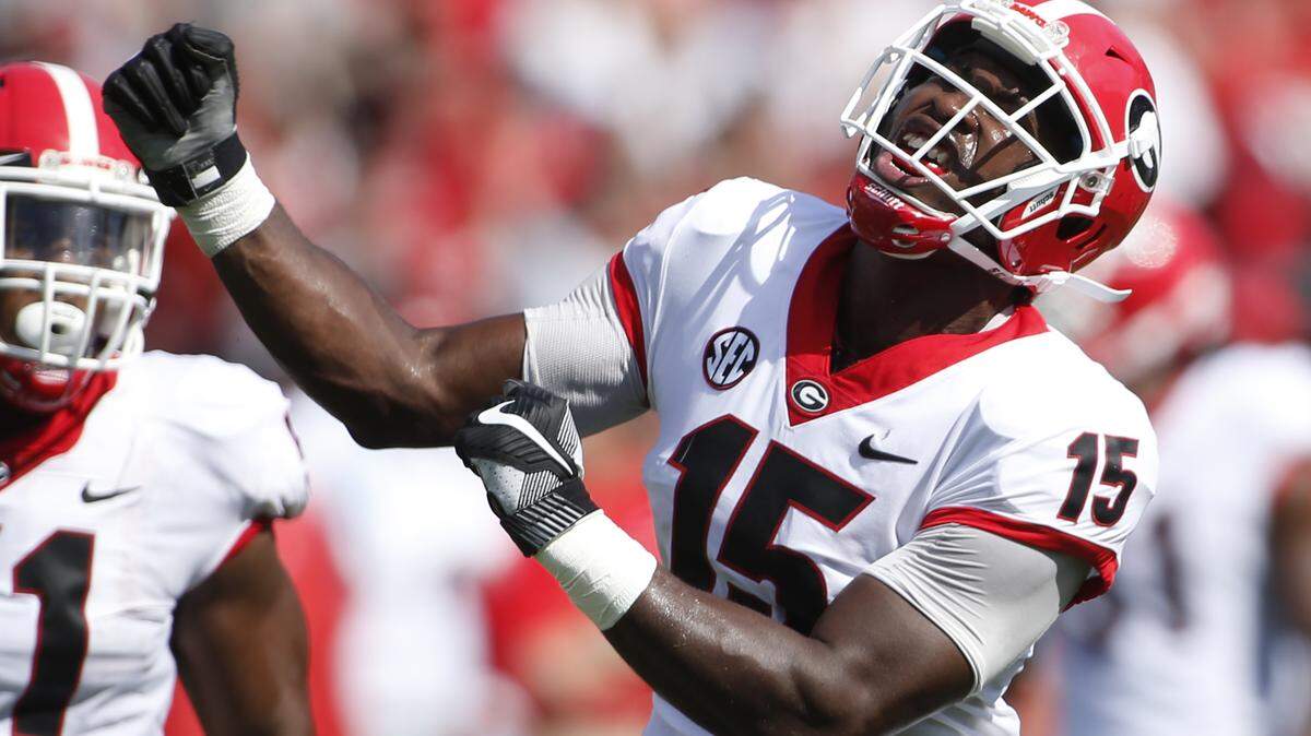 Georgia linebacker D’Andre Walker (15) celebrates after making a play during the first half of an NCAA college football game against South Carolina, Saturday in Columbia, S.C.