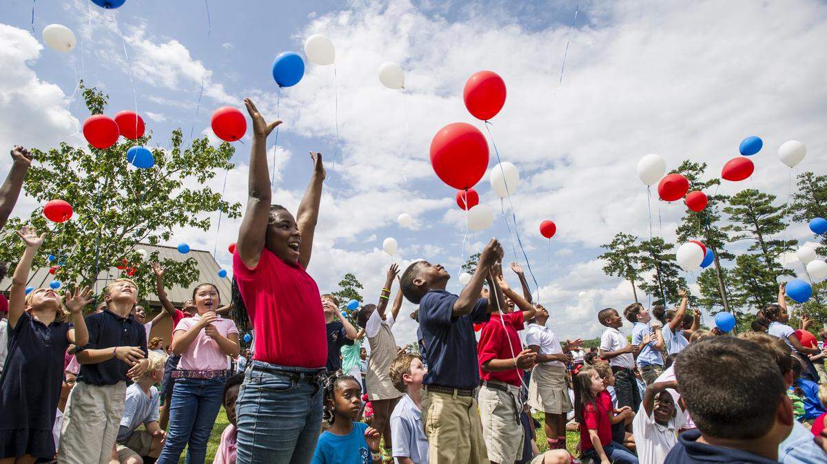 Carter Elementary second grader Adanna Ajoka celebrates her prefect attendance for the school year so far by releasing a balloon with her classmates Wednesday afternoon.