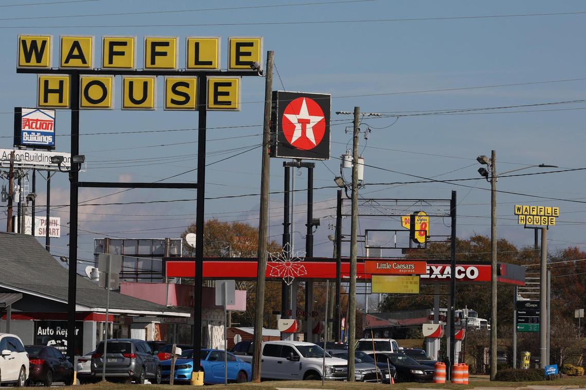 The sign for the I-75 southbound Waffle House sits off of the interstate as the sign for the I-75 northbound Waffle House sits 0.3 miles down the road on Thursday, Dec. 5, 2024, in Byron, Georgia. The two stores are considered “sister” stores and share the same district manager and even supplies and employees.