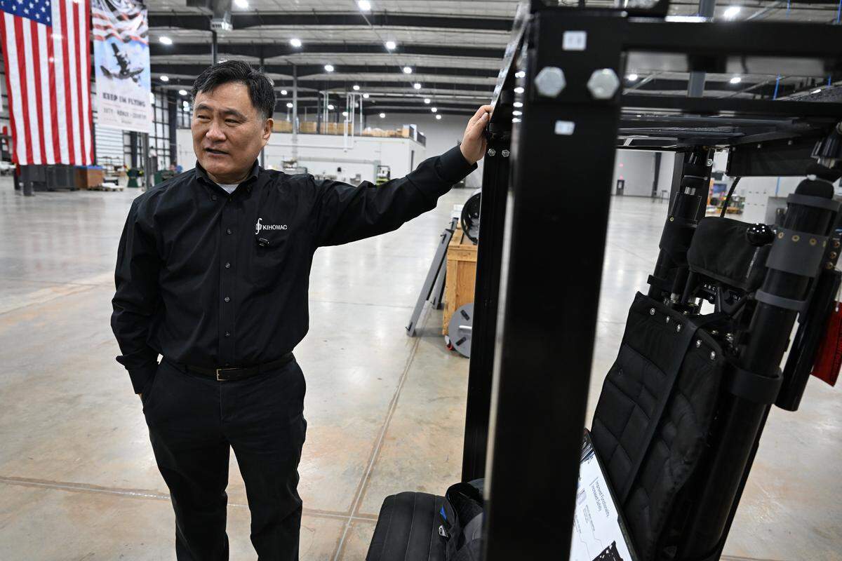 KIHOMAC CEO and founder Ki Ho Kang points out details in a new gunner seat for the Navy’s MH-60S helicopter that the company developed. The seat allows for additional adjustments for angle and height.