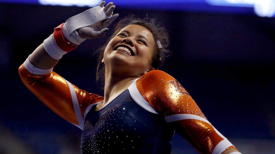 Auburn’s Samantha Cerio smiles and signals to the crowd before competing on the uneven parallel bars during the NCAA women’s gymnastics championships Friday, April 14, 2017, in St. Louis.