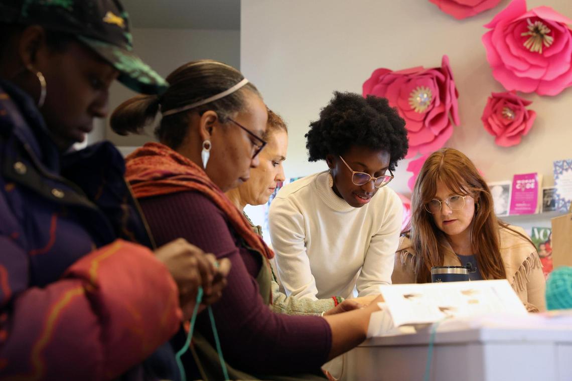 Judah David Creations owner Darice Oppong (second from right) helps team members from Resilience Georgia practice their first stitches in her beginner crochet class on Wednesday, Dec. 11, 2024, at The Web in Macon, Georgia. Oppong started her crochet small business Judah David Creations in January 2024 after learning to crochet after the loss of her son. Now, she sells products and leads classes teaching people the skill.