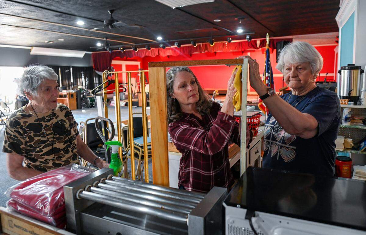 From left, Janis Ball, Sharon Allred and Yvonne Harrington clean the snack bar area at the Powersville Opry’s new location in Hawkinsville March 31. The Opry is moving to Hawkinsville after 27 years at its former location outside of Byron.