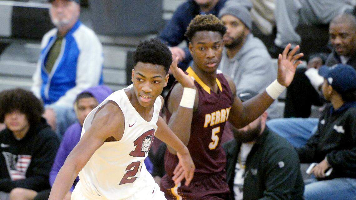 Warner Robins forward Shamar Rouse (25) drives the ball downcourt after stealing the ball intended for Perry’s BJ Wright (5) during the Demons’ 84-52 win Thursday in the Bear Brawl.
