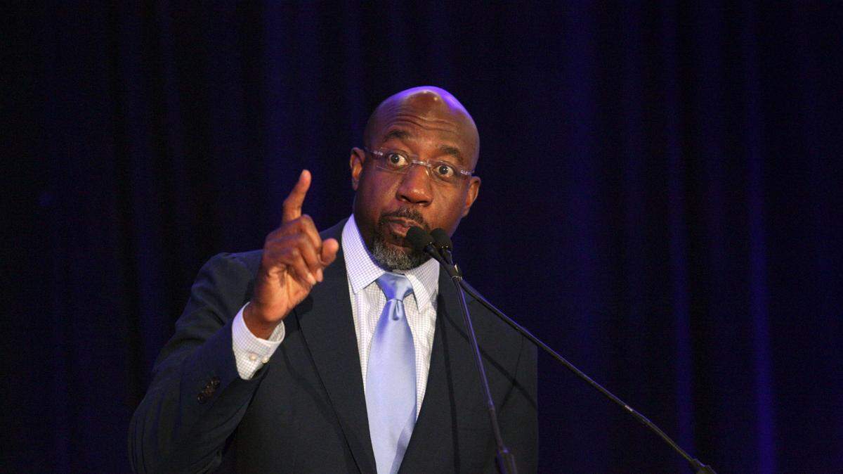 Sen. Raphael Warnock, D-Ga., addresses the Gwinnett County Democratic Party fundraiser on Saturday, May 21, 2022 in Norcross, Ga. (AP Photo/Akili-Casundria Ramsess)