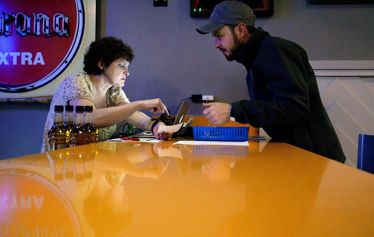 Sherry Meeks, a trivia host for Brainblast, explains the format of a question to Justin Garrison, a first-time trivia participant at Margarita’s in Mercer Village, on Wednesday.