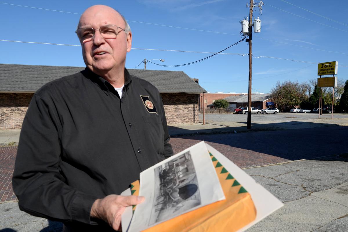 Larry Smallwood, a retired Macon-Bibb fire prevention chief, pulls out an old photo of the building at the corner of Oglethorpe Street and Third Street, which is one of the oldest fire halls still standing in Georgia.