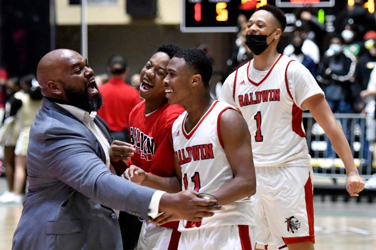 Baldwin players and coaches celebrate their 54-53 last second over Fayette County during the GHSA 4A State Championship game Wednesday night in Macon.