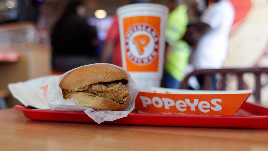 Two Popeyes workers were among those arrested after a dispute spilled into the parking lot, Georgia officials said.