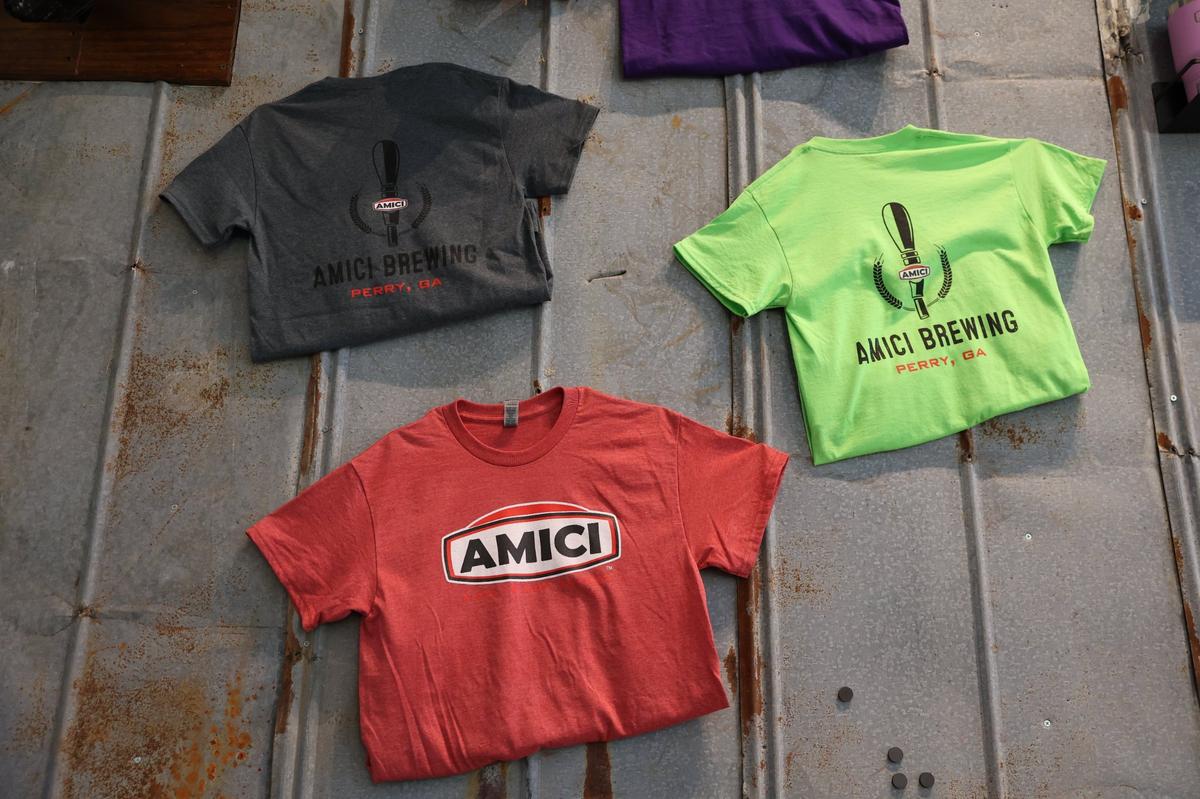 Amici merchandise hangs on a wall in the Perry location of Amici on Wednesday, Oct. 16, 2024, in Perry, Georgia. The new Perry location of Amici is set to open to the public on Monday and will be Perry’s first brewery.