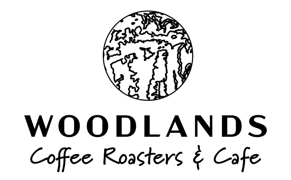 The logo for Woodlands Coffee Roasters & Cafe coming to Warner Robins.