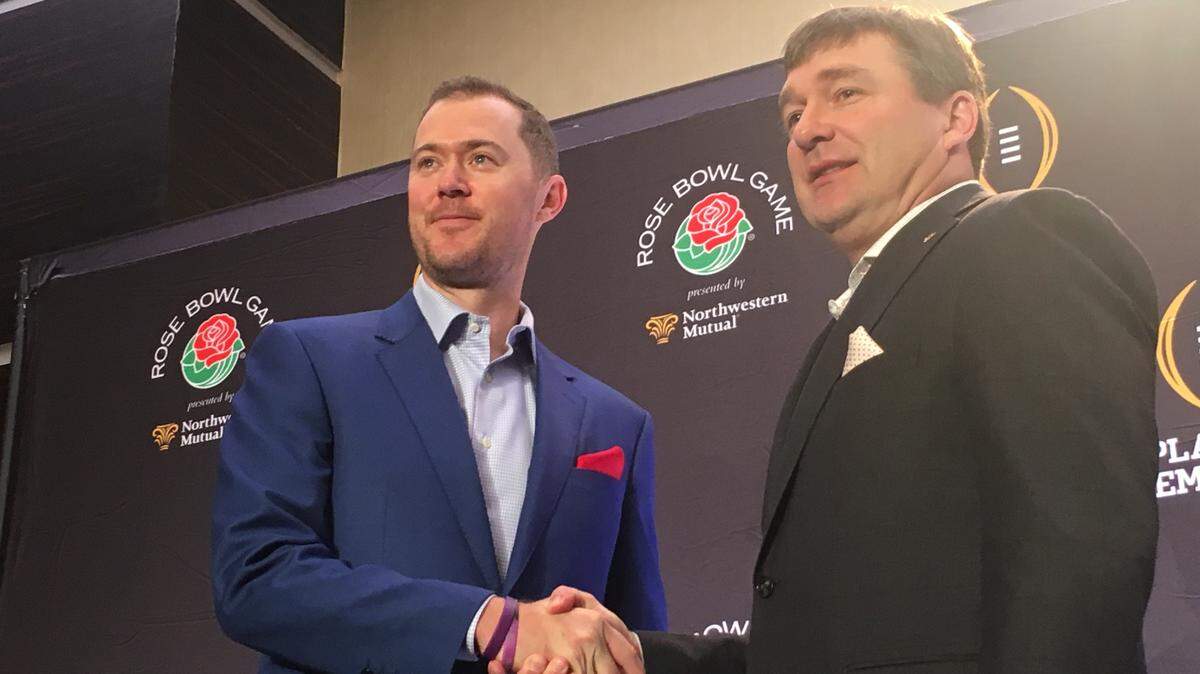 Oklahoma head coach Lincoln Riley (left) and Georgia head coach Kirby Smart (right) shake hands following a Rose Bowl news conference.