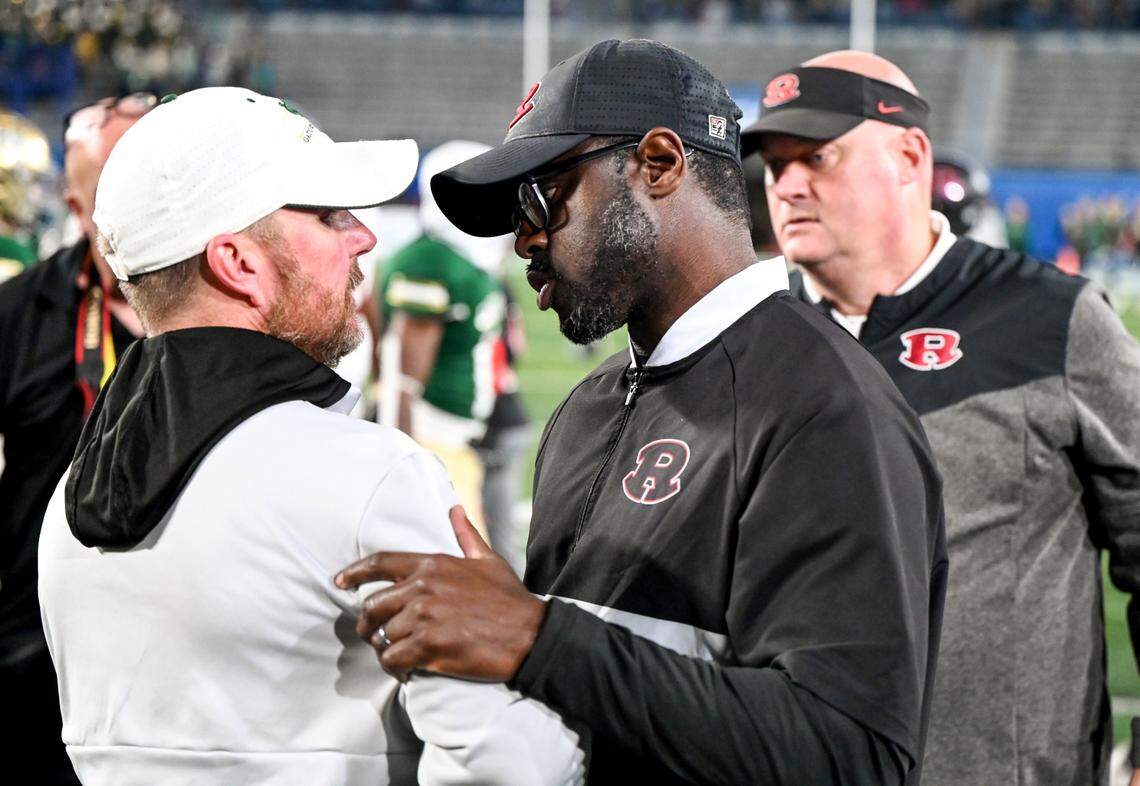 Warner Robins head coach Marquis Westbrook congratulates Ware County head coach Jason Strickland after the Demons’ 38-13 loos to the Gators in the GHSA 5A championship game Saturday in Atlanta.