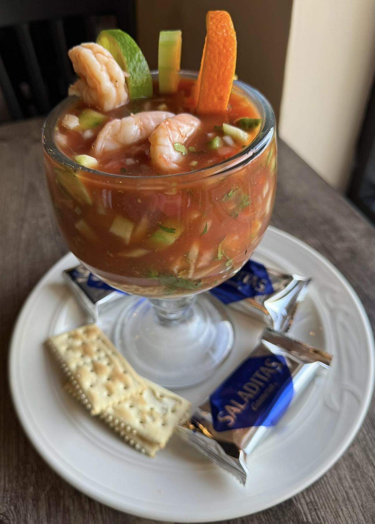 Cocktail de camaron from Cozumel Mexican Grill in Perry. The shrimp cocktail includes cooked shrimp in sweet tomato juice with pico de gallo and garnished with cucumbers and avocado slices and served with lime and saltine crackers.