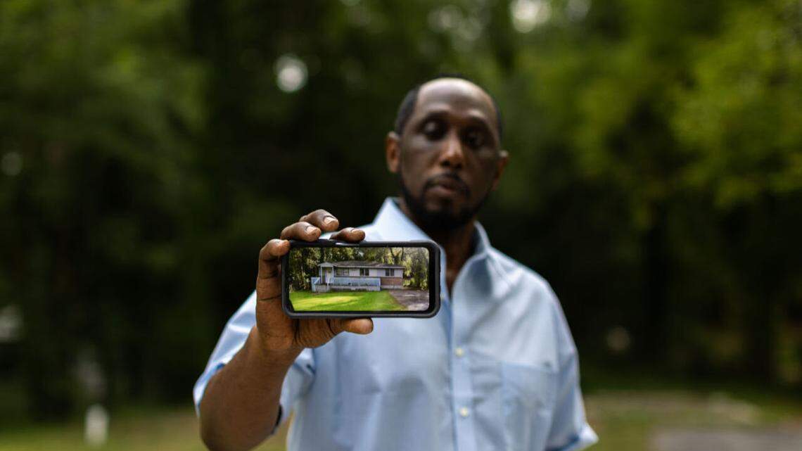 Eric Arnold, owner of 1151 Sunnydale Drive, holds a phone with a picture of what the house he was renovating used to look like before it got demolished by Macon-Bibb County. He’s filing a lawsuit against them for “unconstitutionally” destroying his house.