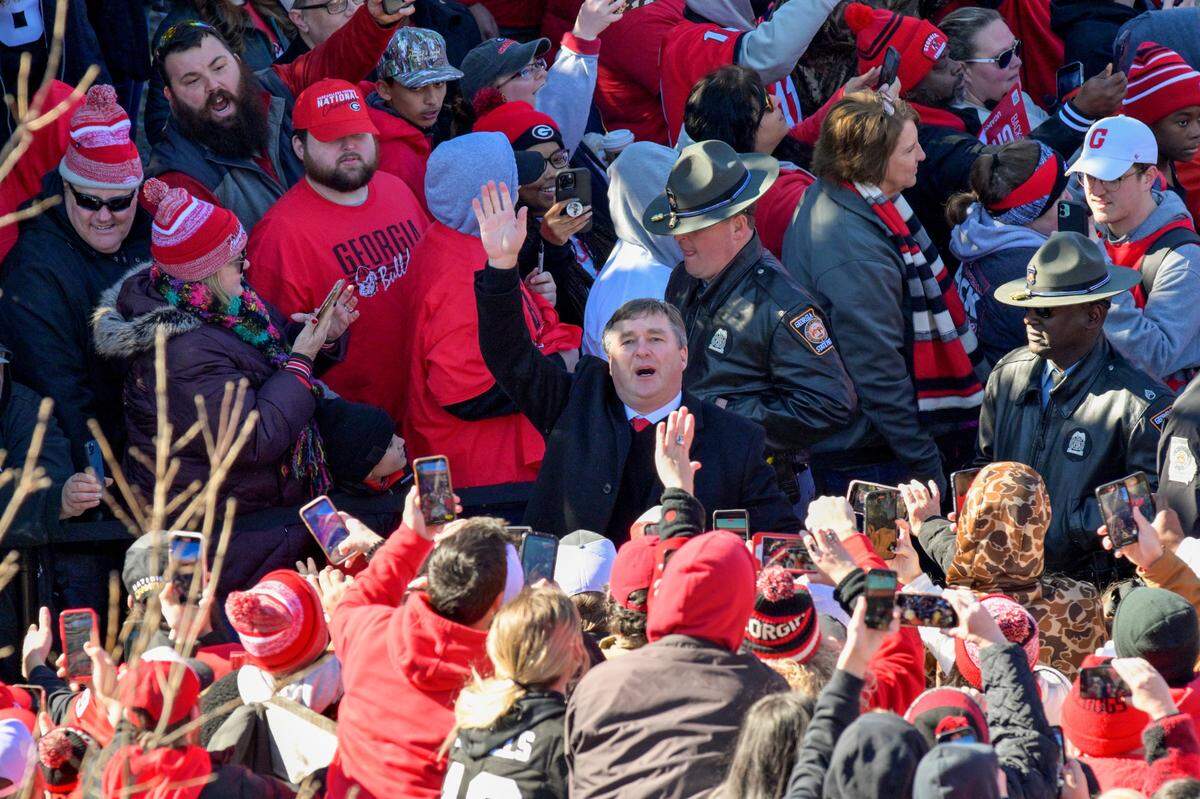 Georgia head coach Kirby Smart waves to the crowd outside Sanford Stadium during Saturday’s celebration in Athens.