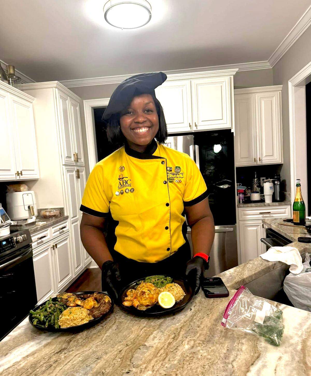 Allegra Lowe, owner of ABC Catering LLC, prepares an anniversary meal for a couple in their home.