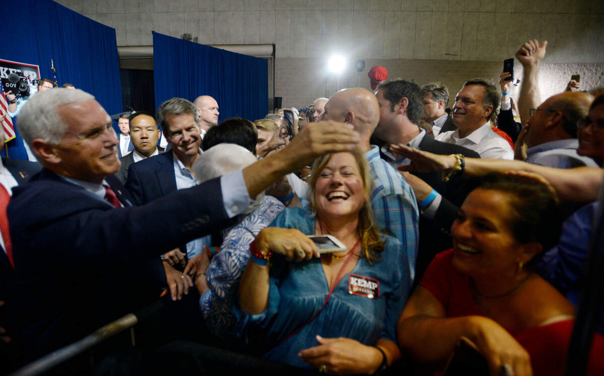 Vice President Mike Pence, left, shakes hands over Mindy Horn, right, of Macon after Pence delivered an endorsement speech for gubernatorial candidate Brian Kemp, second from left. About 1,000 people attended the July rally at the Wilson Convention Center.