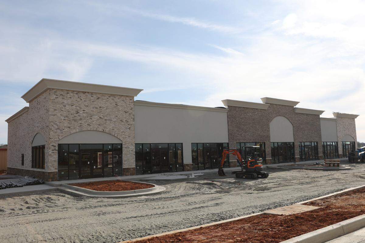 A Surcheros Fresh Mex, Holy Pie! Pizzeria, a Flo & Glo IV Wellness Lounge, a pharmacy with a drive-thru, and a nail salon are expected to open in this shopping plaza, part of the Perry Parkway Project under development at the corner of Perry Parkway and Houston Lake Road shown here on Monday, March 3, 2025, in Perry, Georgia.
