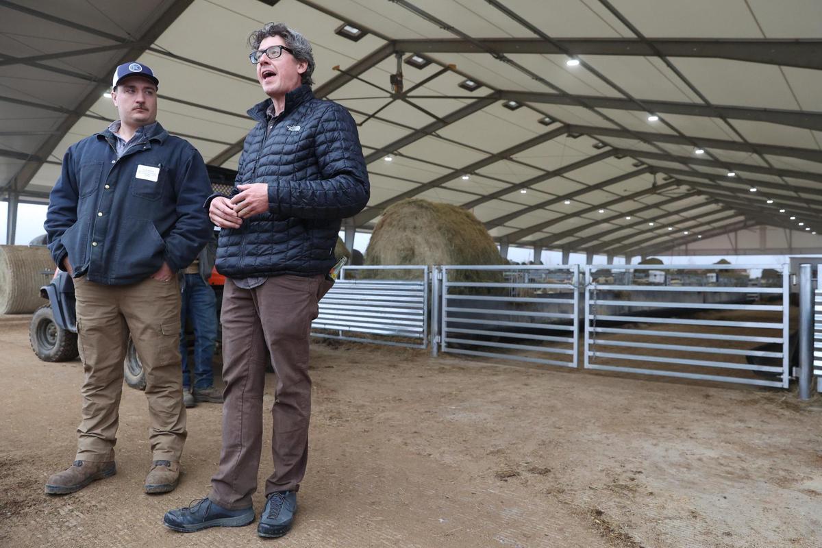 Houston Solar ranch manager Jack Mason (left) stands with Silicon Ranch agrivoltaics operations director Jim Malooley outside of the lambing barn at Houston Solar Project on Wednesday, Feb. 12, 2025, in Elko, Georgia. The lambing barn, which finished in late 2023, currently holds hundreds of sheep and lambs, which are monitored, recorded and then released out to the pasture. Silicon Ranch breeds its own sheep to enhance parasite resistance and to adapt to the climate in the southeast.