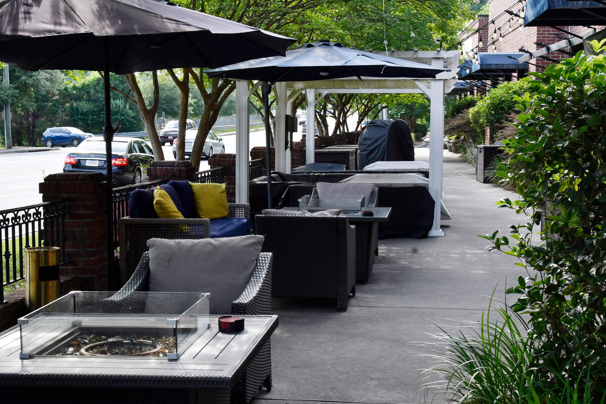 Sip a cocktail in the shade with a warm firepit and snug seating. The patio of Marie’s Lounge sits off of Forsyth Road on Thursday, May 23, 2024, in Macon, Georgia. 