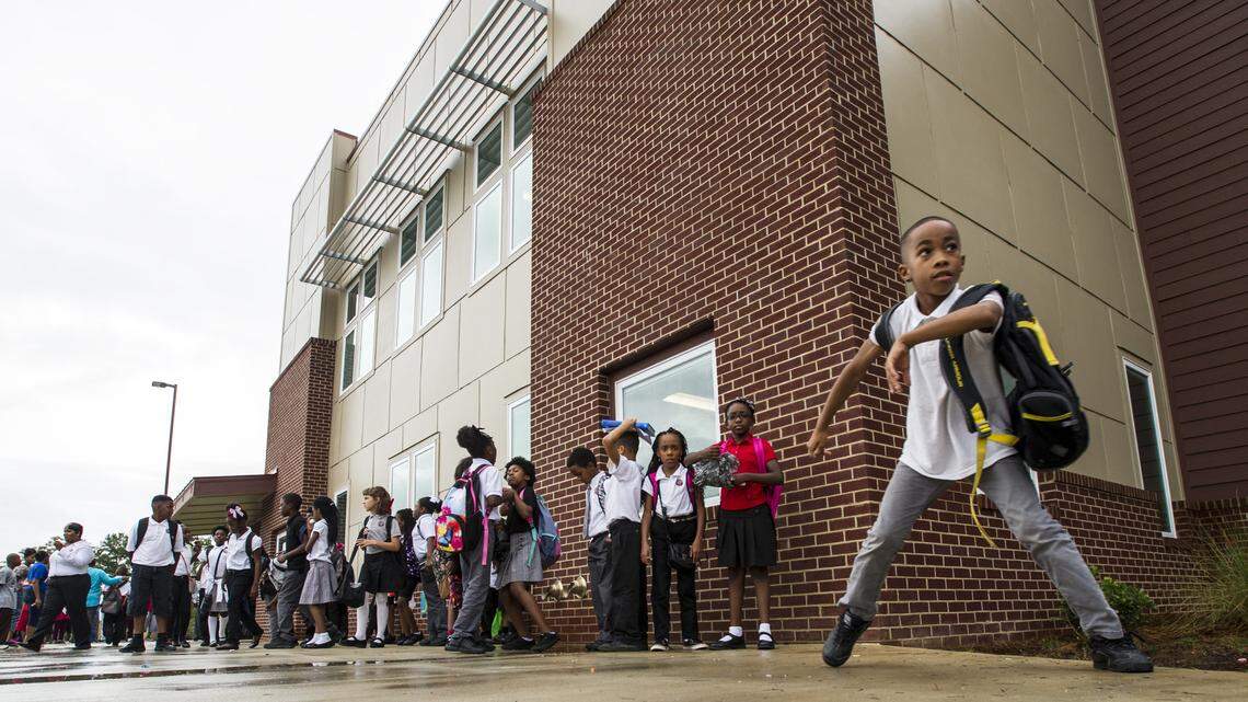 Children wait outside Macon Charter Academy for school to be dismissed.