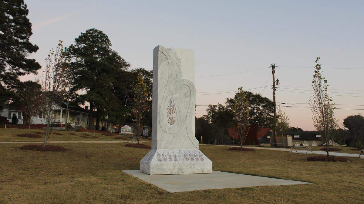 Bicentennial Park features a sculpture of a Muscogee stick ball warrior and flames, surrounded by grass and a walking path on Thursday, Nov. 13, 2025, at 271 Clinton St. in Mill Hill, an east Macon neighborhood.