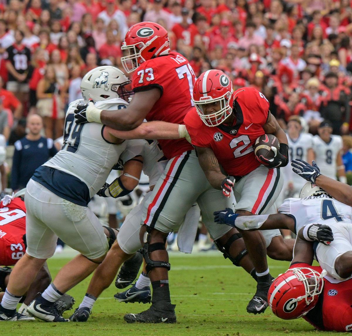 Georgia running back Kendall Milton (2) finds a crease and picks up 7 yards for a first down during the Bulldogs’ 33-0 win over Samford Saturday in Athens.
