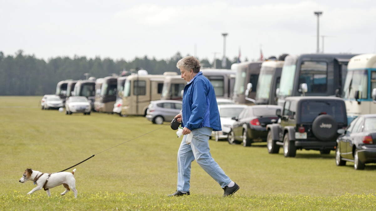 Millie Green walks her 11-year-old Jack Russell terrier, Jessie, last week at the Georgia National Fairgrounds and Agricenter in Perry during the Family Motor Coach Association Family Reunion and Motorhome Showcase.