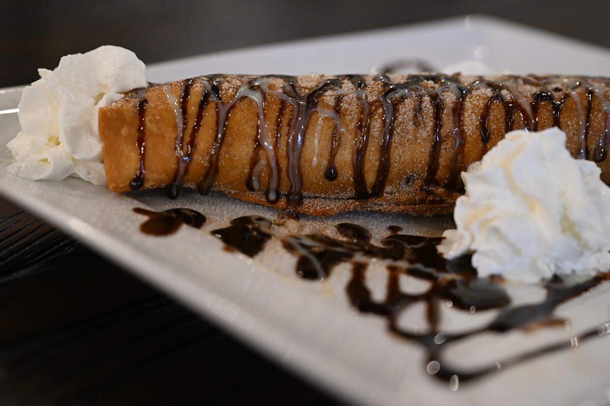 The banana burrito from Fuego Fresco Mexican Restaurant on Thursday, Aug. 28, 2025, in Perry, Georgia. The dessert features a banana wrapped in tortilla, then deep fried, and topped with chocolate and condensed milk.