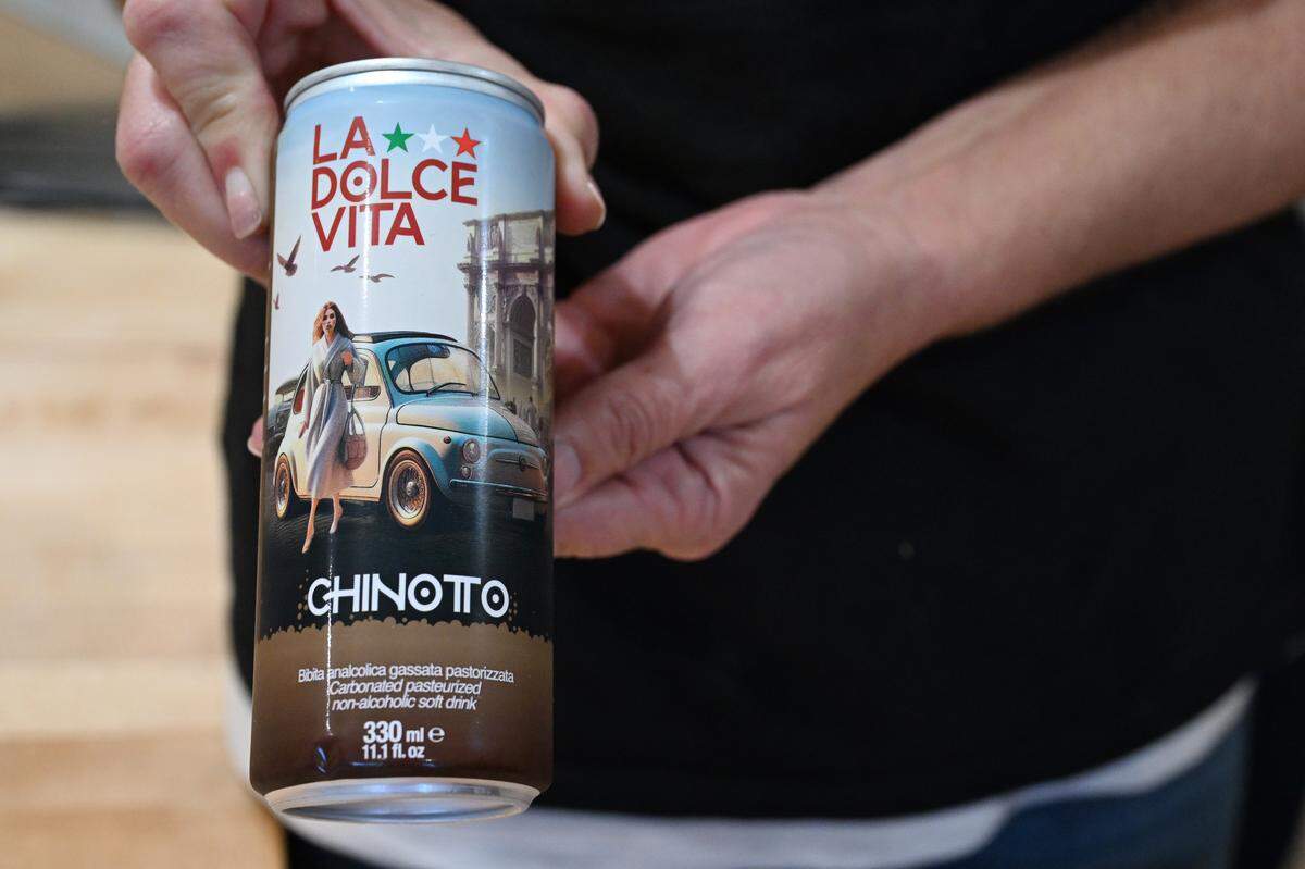 Telisa Asaro shows an Italian “La Dolce Vita Chinotto” soft drink that is offered in Ciao Bella Market in downtown Perry. In addition to Italian products, the market sells Italian sandwiches and beverages.