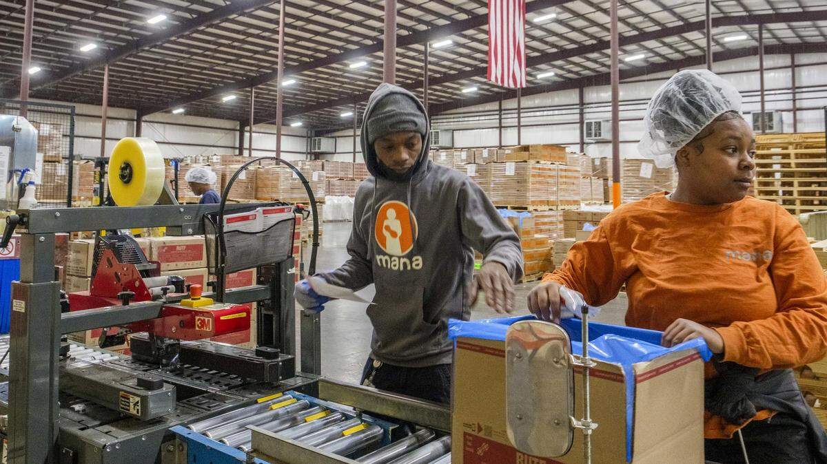 Jeremy Robinson, center, and Aliyah Hill, perform last checks on packets of MANA Nutrition emergency food supplements for children before packaging them in the non-profitÕs factory in Fitzgerald. ÒWe save lives,Ó Robinson said of his part of the work that has saved millions of children globally.