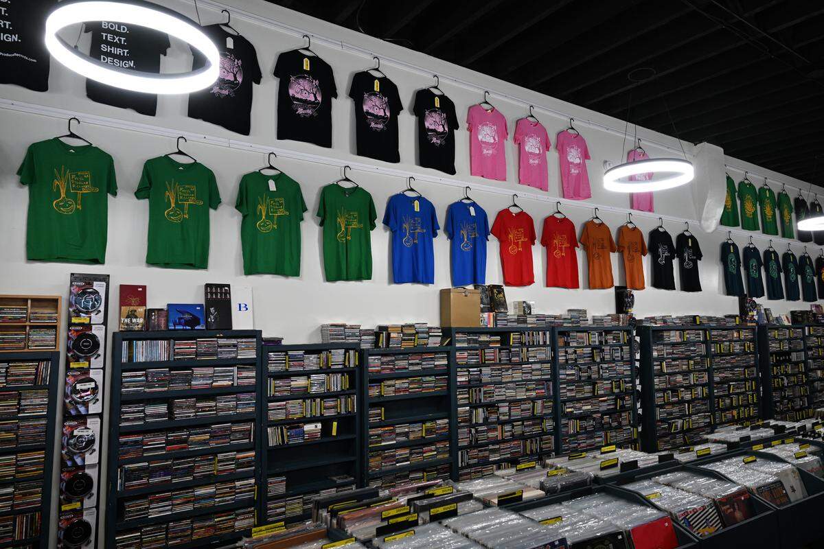 Rows of merchandise, cassettes and CDs line the walls of the expanded storefront of Fresh Produce Records on Tuesday, Sept. 2, 2025, in downtown Macon, Georgia. The majority of the media in the new storefront was in storage without sufficient space in the original shop. 