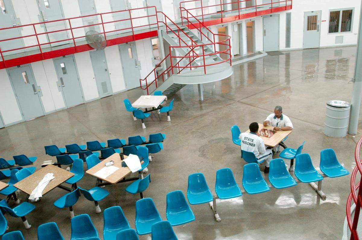 Lafayette Hall plays chess with a fellow inmate in his jail wing at Hancock County State Prison in late 2003.