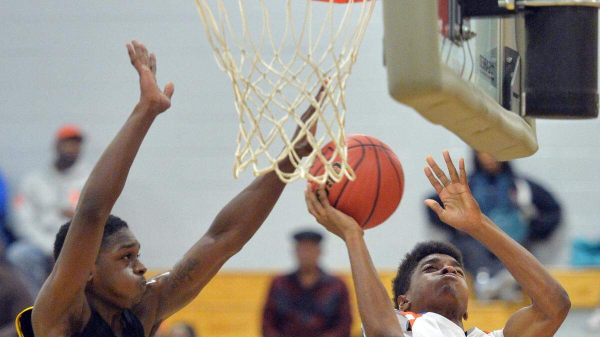 Central's Dewan Owens, right, beats Josey defender Javen Whitehead to the basket for a score during the Chargers' win Wednesday in the first round of the GHSA Class AAA Tournament.