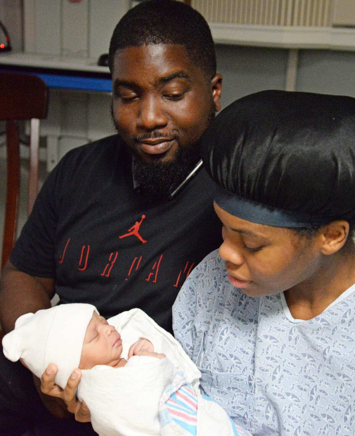 Ray Clark and Brittany Hunt, left to right, hold their new baby, Braylon, at Navicent Health. Hunt arrived at the hospital and had her baby during Hurricane Michael.