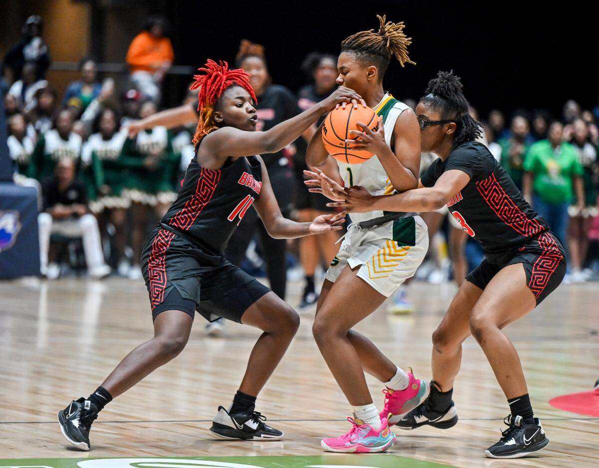 Baldwin’s Zykeria Paschal (14) and Madison Ruff (3) pressure Griffin’s Leah Turner (1) in the final seconds of their GHSA 4A State Championship Wednesday in Macon.