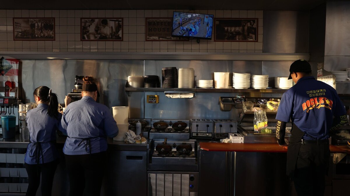 Employees at the I-75 northbound Byron Waffle House prepare food and pour coffee during a morning shift on Thursday, Jan. 16, 2025, in Byron, Georgia. Although they’re not the two closest Waffle Houses in Georgia, the Exit 49 Byron Waffle Houses sit just 0.3 miles apart on the same road.