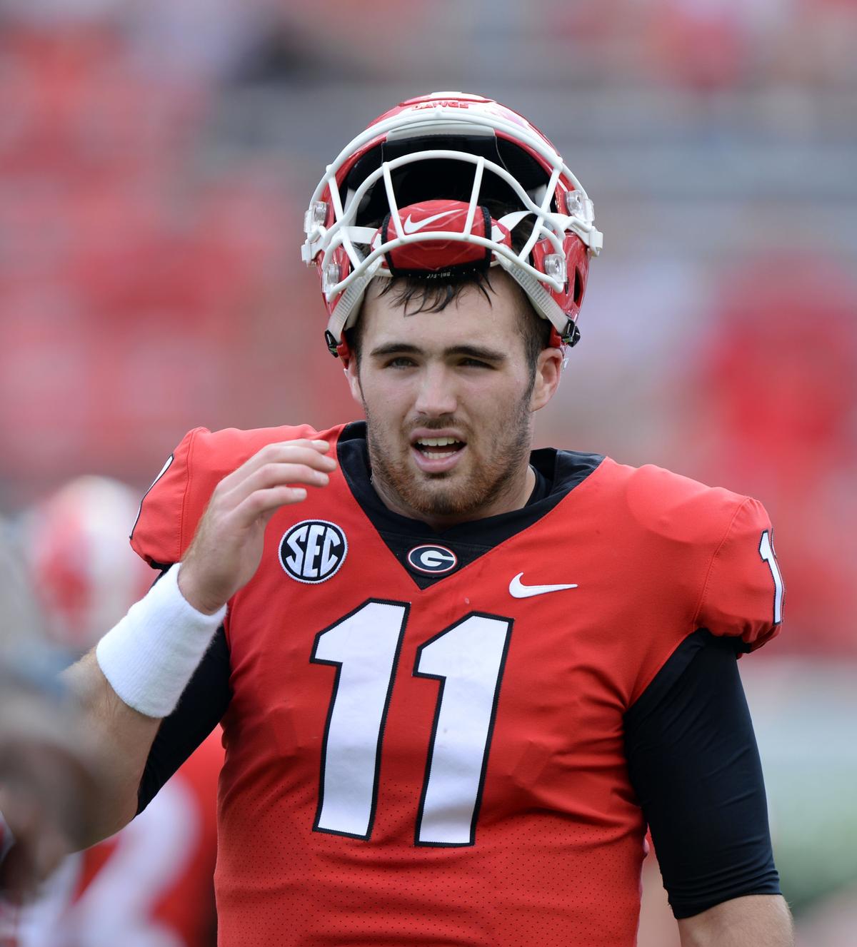 Georgia quarterback Jake Fromm tips his hat as he and the Bulldogs get ready for Tennessee.  Georgia beat Tennessee, 38-12.