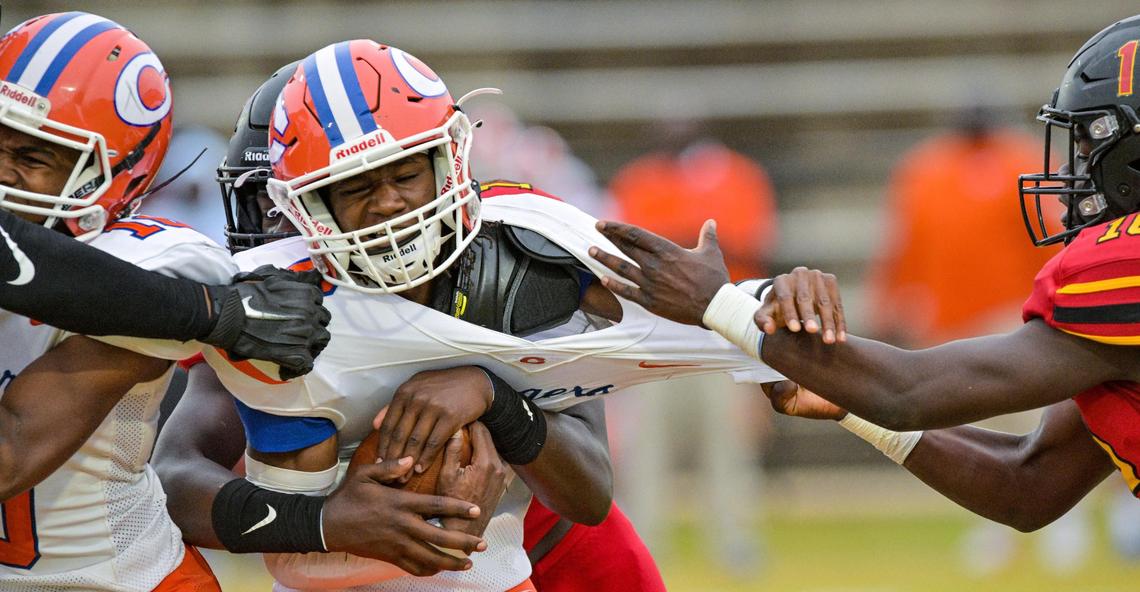 Central quarterback Torey Flowers gets sacked by several North East defenders Thursday night at Henderson Stadium.