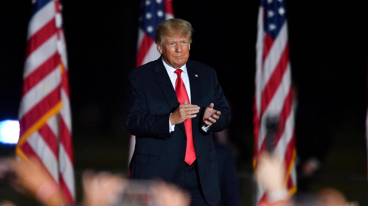 Former President Donald Trump enters a stage in the Georgia National Fairgrounds in Perry on Saturday, Sept. 25. Trump was joined at a rally by several Georgia politicians and candidates, including Herschel Walker and Rep. Jody Hice.