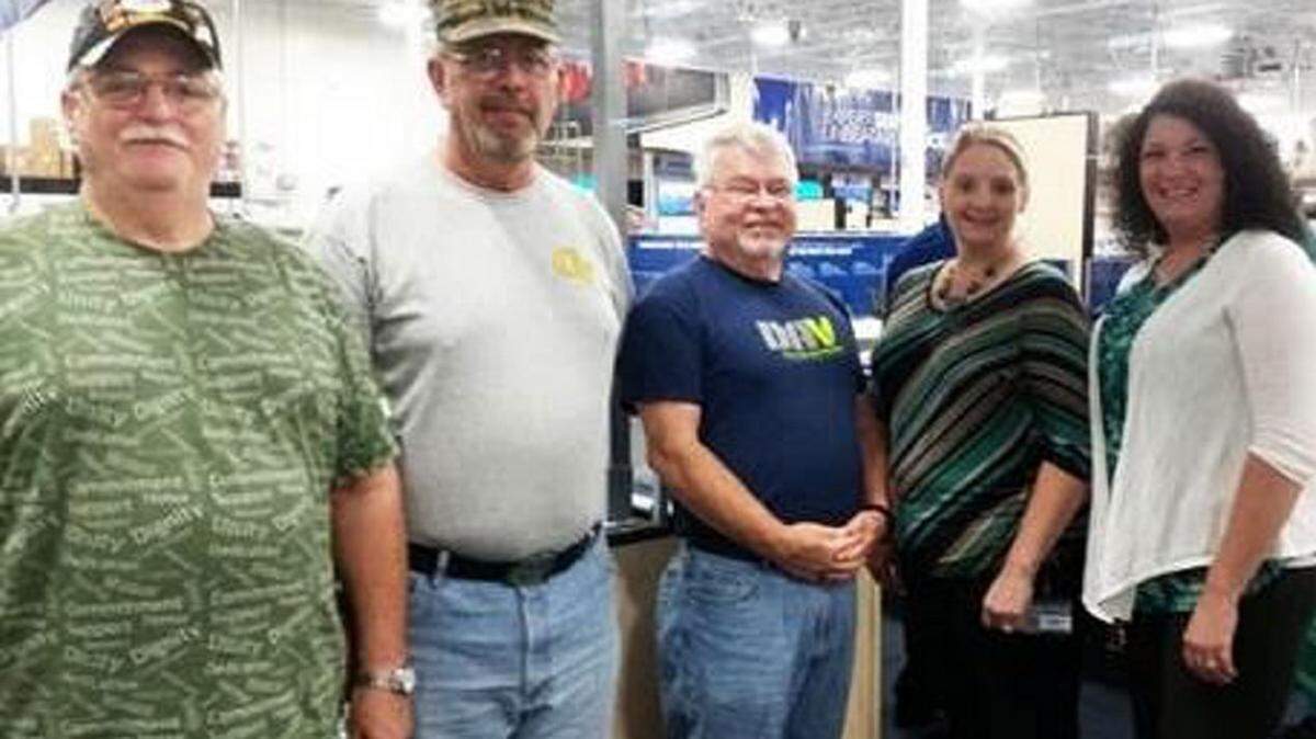 From right, Hillary Bobbitt, communications specialist, and Brandy Newman, assistant branch manager, at Robins Federal Credit Union, with Rick Newman, John Morgan and Burl Jimmerson of Disabled American Veterans Chapter 33. The credit union replaced two computers that were stolen from the nonprofit agency in a break-in. Others in the community also helped the agency get back on its feet.